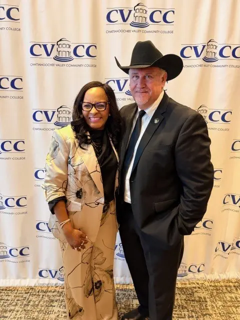 Two people posing at a CVECC event, dressed formally.